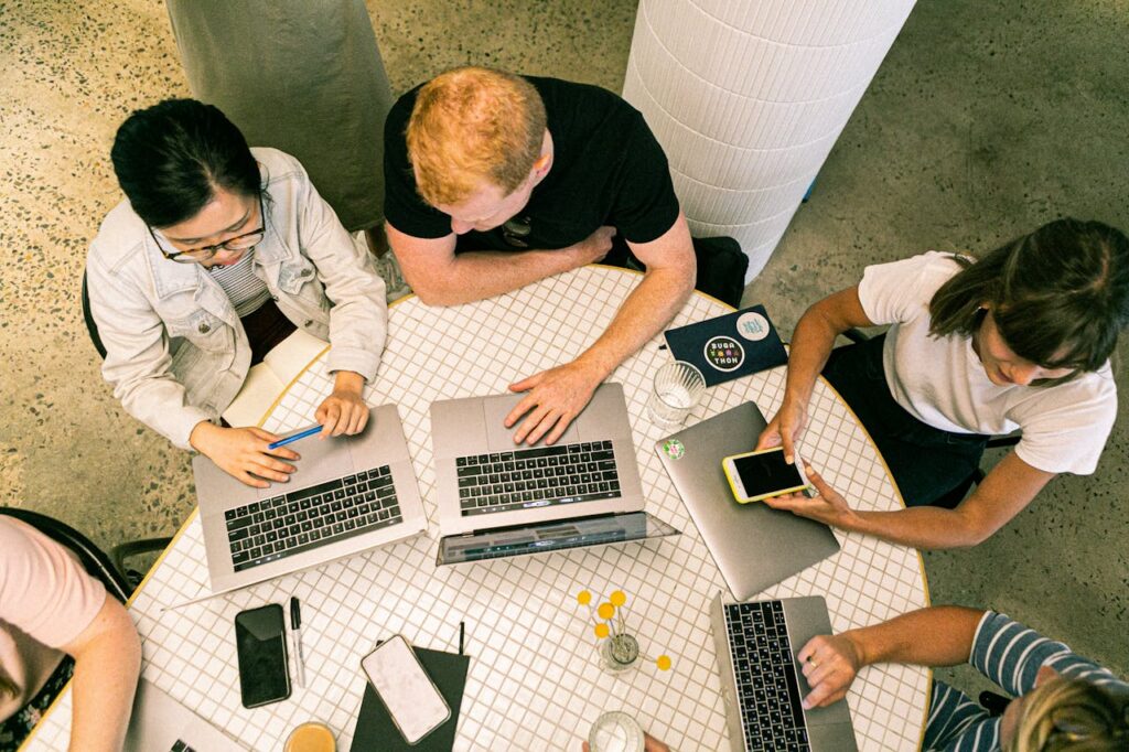 The Art of Drawing Readers In: Your attractive post title goes here Top view of diverse team collaboratively working in a modern office setting.